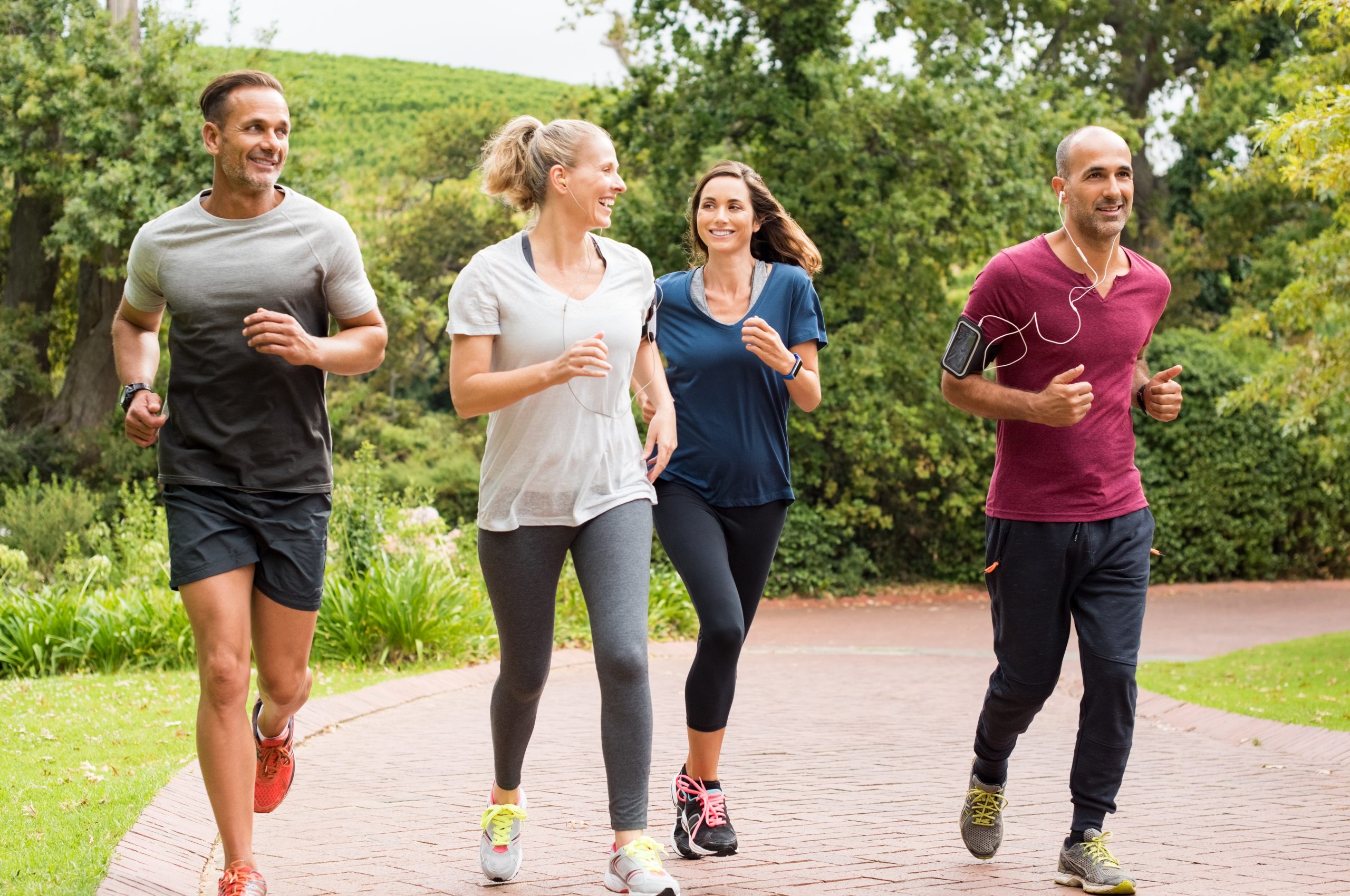 Healthy,Group,Of,People,Jogging,On,Track,In,Park.,Happy