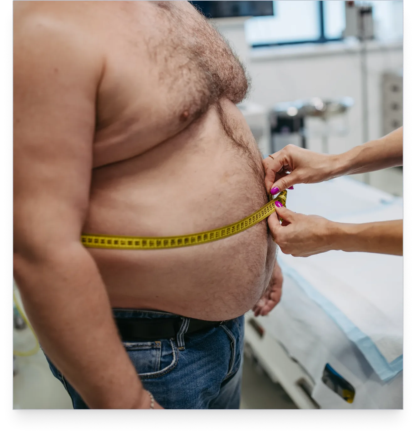 Clinician measuring a patient's waistline